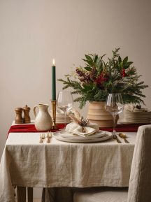 Festive table setting with a floral centrepiece and a lit candle